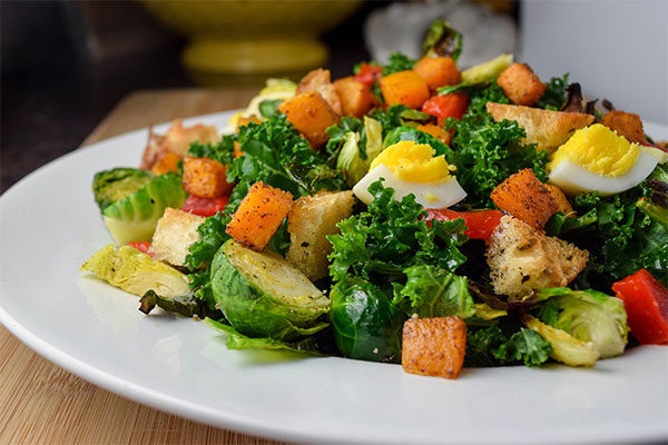 Kale Salad with Butternut Squash, Brussel Sprouts, and Roasted Red Pepper