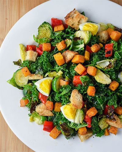 Kale Salad with Butternut Squash, Brussel Sprouts, and Roasted Red Pepper